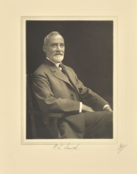 Three-quarter length seated studio portrait of T.L. Smith, Milwaukee manufacturer.