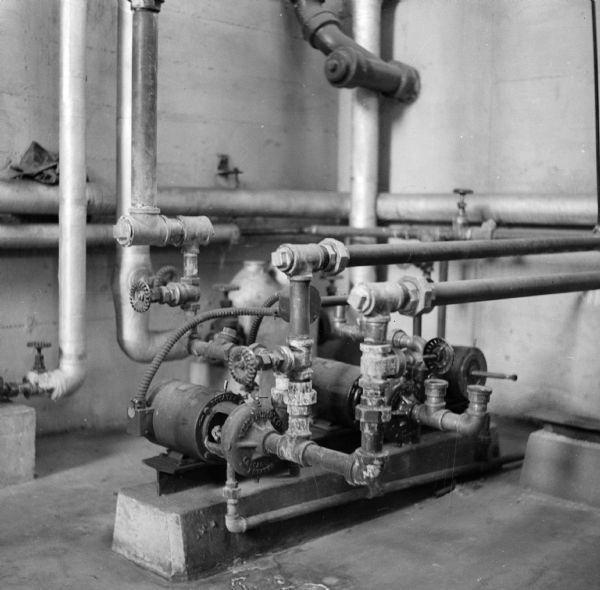 Hydraulic pump and pipes, most likely in a sewage treatment plant.