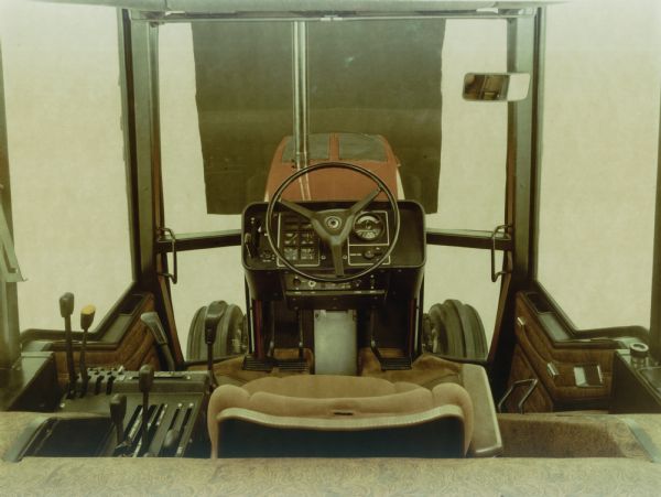 Color photograph of the interior of an International Harvester 3688 tractor cab looking forward. The tractor has the optional "Western" interior and dash.