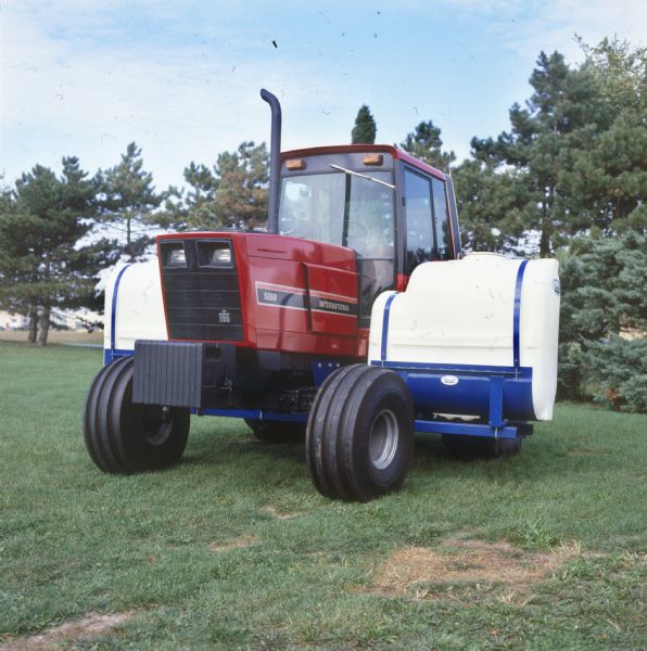 Color photograph of an International Harvester 5288 tractor with Broyhill side-mounted fertilizer tanks in a field.