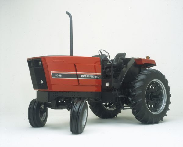 Color studio shot of side of International Harvester 3088 tractor without ROPS (roll-over protection system).