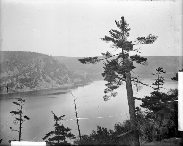 Elevated view across Devil's Lake from the West Bluff. Railroad tracks are seen along the base of the East Bluff.