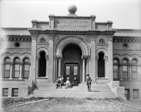 A group portrait of three women and two men outdoors on the steps of the Yerkes Observatory, a facility of the University of Chicago.