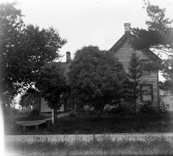 E.D. King residence, once a post office, at King's Corners.  A wooden walkway with a ramp at the roadside extends from the front door.