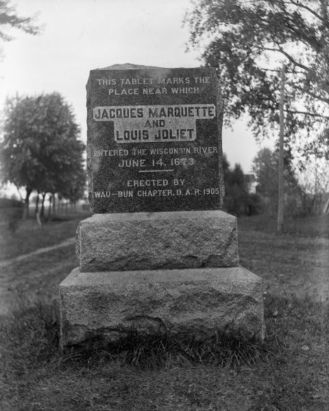 A view of the Marquette-Joliet historical marker. Erected by the Wau-bun Chapter of the Daughters of the American Revolution.