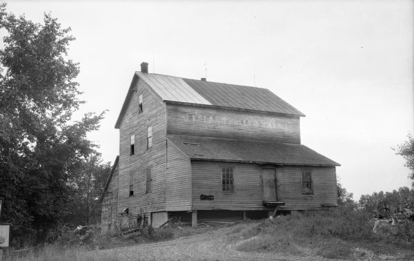 The inactive Leland mill, with the faded painted sign, "Leland Roller Mill," on the upper story.