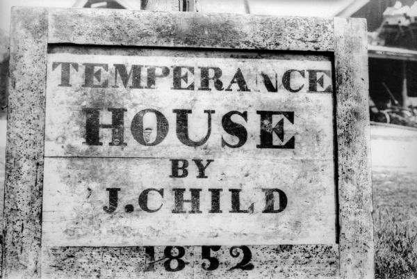 A worn, painted wooden sign reads: "Temperance House by J. Child 1852."  It was "at Lima Center, the first house south of the cemetery on the main road between Janesville and Milwaukee."