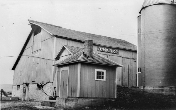 The barn of W.A. Dean, built in 1844 and used as a stage barn in the stage coach days. The barn's foundation, silo, and milk room are newer.