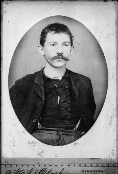 A copy of a waist-up portrait of Raymond Holzse.  Holzse was described as a "bandit of northern Wisconsin, who planned several stage holdups."