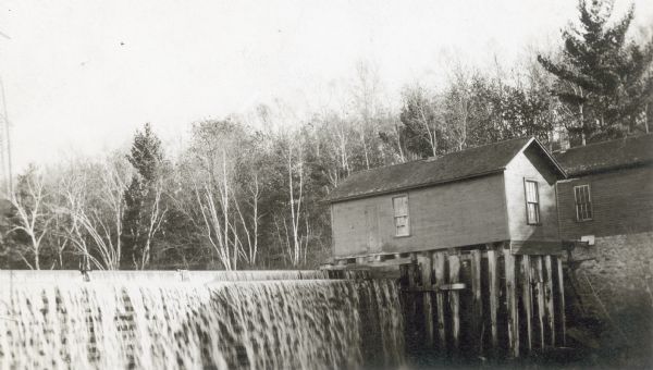 A dam and small mill building on the Willow River. The plant, built by Christian Burkhardt as part of the Burkhardt Milling and Electric Power Company, operated from 1892 until 1914 and transmitted electricity over a power line for one mile to a flour mill. It was one of the earliest plants with a transmission line.