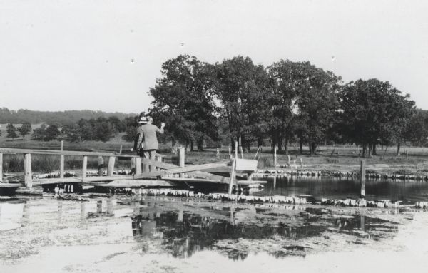 Charles E. Brown (pointing) and A.O. Barton, both of Madison, stand on a boardwalk at Blue Spring. The spring feeds the lake of the same name.