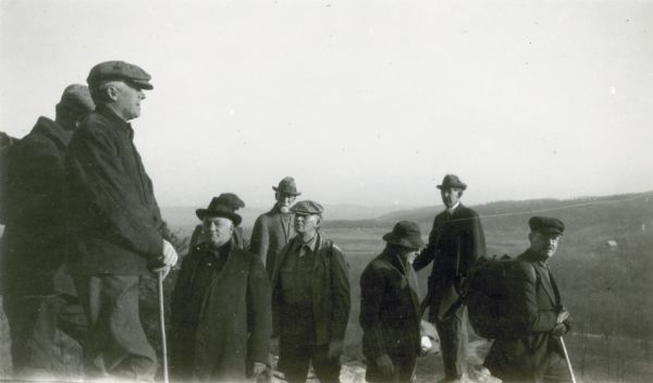 Members and guests of the Heart of the Hills Walking Club pose on a bluff near Devil's Lake. H.E. Cole stands second from right.