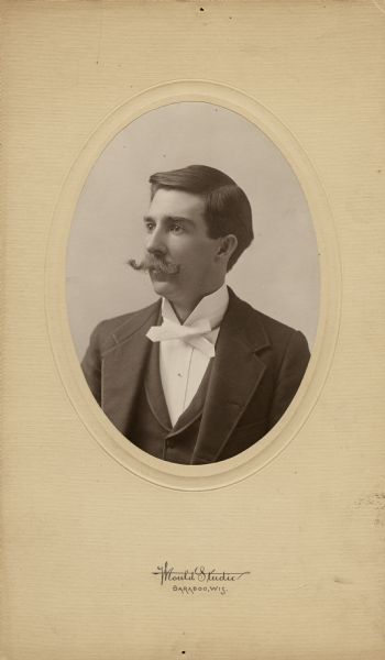 Quarter-length studio portrait of Harry Elsworth Cole (1861-1928), founder and first president of the Sauk County Historical Society and president of the State Historical Society of Wisconsin. He was also an organizer of the Wisconsin Archeological Society. Cole was the editor of the <i>Baraboo News</i>, as well as an author and photographer.