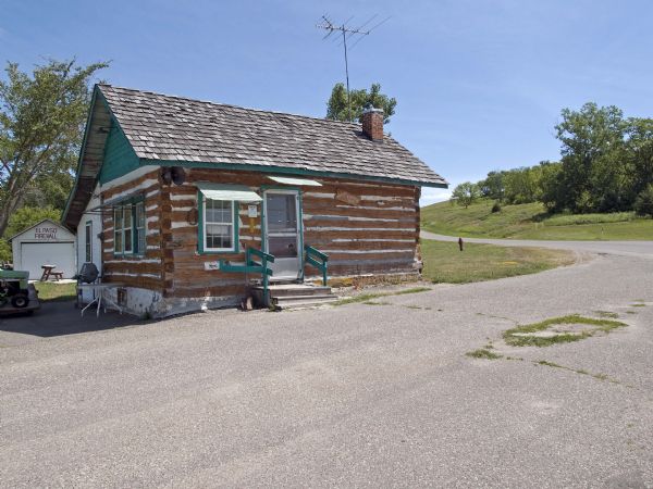 Knute Bjornson originally built this house in the 1860's and in 1933, his grandson Cooney Bjornson reassembled the humble log building to house a gas station and tavern business.