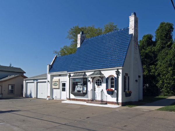 Clarence "Slim" Fritag's Pure Oil service station, located at 1323 Ninth Street, created a sensation in 1935 when the local newspaper announced that "an attractive new brick station, finished in white and blue, has been completed. It is of unusual design, with high peaked roof and weathered copper trim."