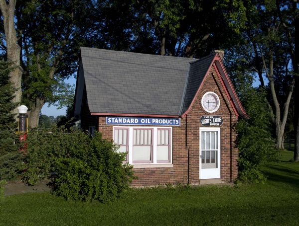 Constructed of red brick and capped by a steeply pitched gable roof accented with gently flared eaves, this one-story station, built in the mid-1920s, resembled an English cottage.