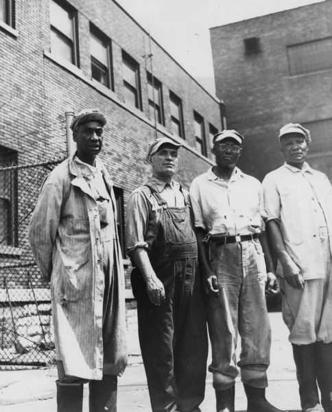 Four members of the United Packinghouse Workers of America Local 56 employed at the Illinois Meats Company: (left to right) Bill Murdock, Mike Mickle, Bill Smith, and Peter Chirwnoak.