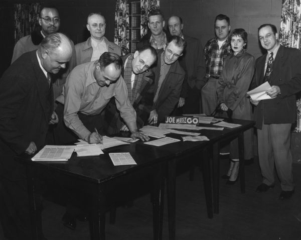 Members of United Packinghouse Workers Local 40 signing a "Joe Must Go" petition to recall Wisconsin's Senator Joseph R. McCarthy.