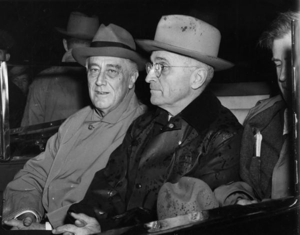 President Franklin D. Roosevet, Vice-president elect Harry Truman, and Henry Wallace, the sitting vice-president, riding together in an open car shortly after the election. FDR, obviously ill and tired, died only a few month later, and Truman, about whom little was known by the public, became the President. Wallace had been dumped from the ticket, and an alternate and more frequently seen view of the event taken by Abbie Rowe, has been captioned to suggest that Wallace had relocated to the backseat. This view make it clear the three men were seated in a row.