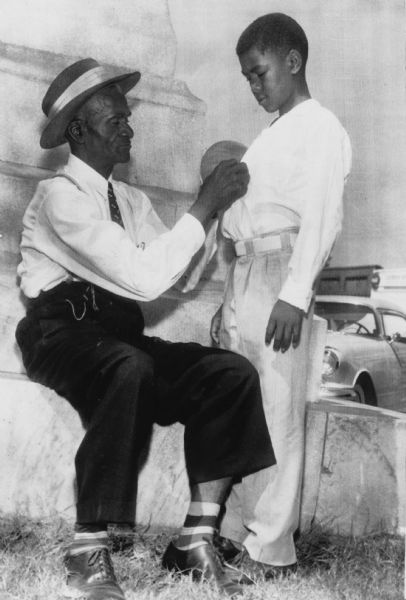 Rev. Moses Wright and his son Simon outside the Sumner courthouse where two white men were on trial for the murder of 14 year-old Emmett Till (Wright's nephew), for allegedly whistling at a white woman. The two defendants had abducted Till from Wright's farmhouse where Till and Simon Wright were sleeping in the same room. Despite Rev. Wright's brave identification of the men at the trial, the two defendants were acquitted.