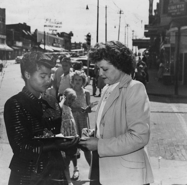 Emma Milton (left) of Omaha, a member of United Packinghouse Workers Union local 60, is seen here circulating a petition to save the rent control instituted during World War II. The deregulation election was scheduled for November.