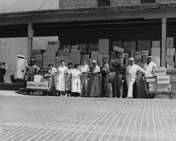 Informal outdoor group portrait of several Cudahy employees who were members of the United Packinghouse Workers of America Union.