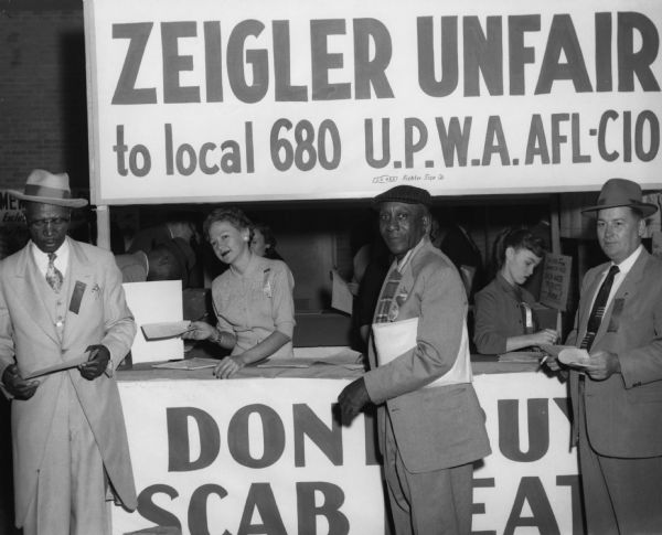 A booth at an Alabama fair (probably at Florence) sought support for the striking members of United Packinghouse Workers Local 680 who worked for the R.L. Zeigler Company. A banner on the booth urged: "Don't Buy Scab Meat."