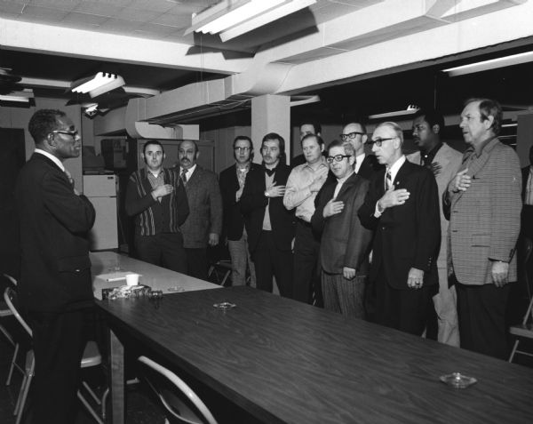 Hilton Hanna (left), a national leader in the Amalgamated Meatcutters and Butcher Workers union, swears in the new officers of Local 248 in Milwaukee.