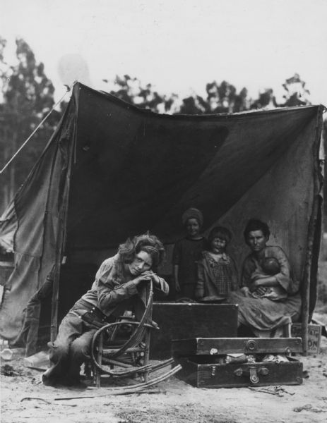 Florence Thompson with several of her children in a tent shelter as part of the "Migrant Mother" series.