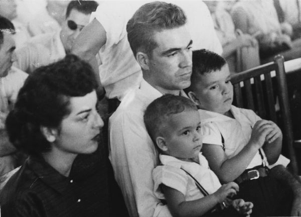 Roy Bryant, one of the two men charged with the murder of Emmett Till who had allegedly whistled at Bryant's wife, Carolyn. She sits at Bryant's right, and Roy holds their two sons in his lap. Bryant was acquitted of the murder charge, but the incident did much to galvanize the civil rights movement of the 1960s.