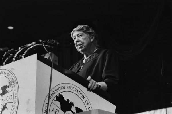 Eleanor Roosevelt addressing a labor union audience from a podium.