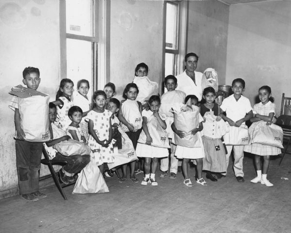 Children of striking Peyton Packing Company workers, all of Latin American descent, with gifts sent by union members in Wichita Kansas.