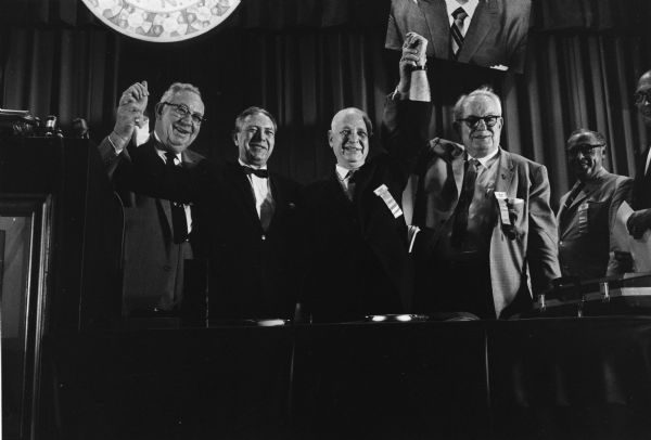 Patrick Gorman (right) of the Amalgamated Meatcutters and Butcher Workers Union, and next to him, Ralph Helstein of the United Packinghouse Workers of America, raise their hands at their 1968 merger convention.