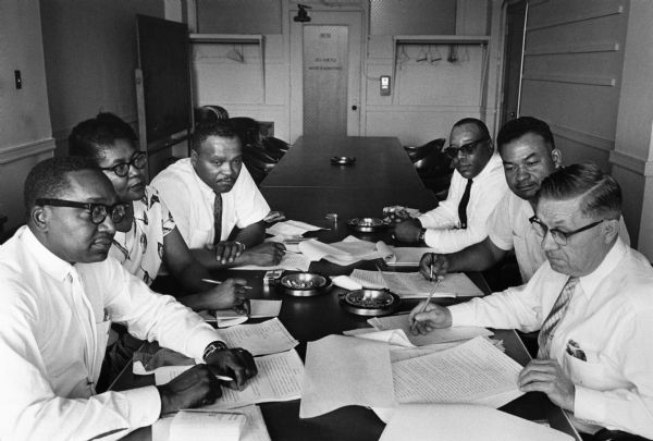 The bargaining team for a newly-recognized United Packinghouse Workers local at the Agar Packing Company talk over strategy for their first contract talks with UPWA representatives. On the right is International representative Edward Filliman, and next to him is organizer Horace Wells.