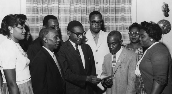 Donald Hankins (third from the right), president of United Packinghouse Workers Local 569, hands a $500 check for an NAACP life membership to Arthur Johnson, of the Detroit NAACP.