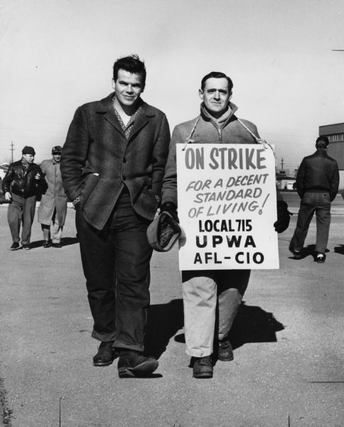 Employees of the Wilson Sporting Goods Company in suburban Chicago are Bob Pickles and Ed Cronk. The men were representing the United Packinghouse Workers of America union because Wilson Sporting Goods was a subsidiary of the Wilson Packing Company.
