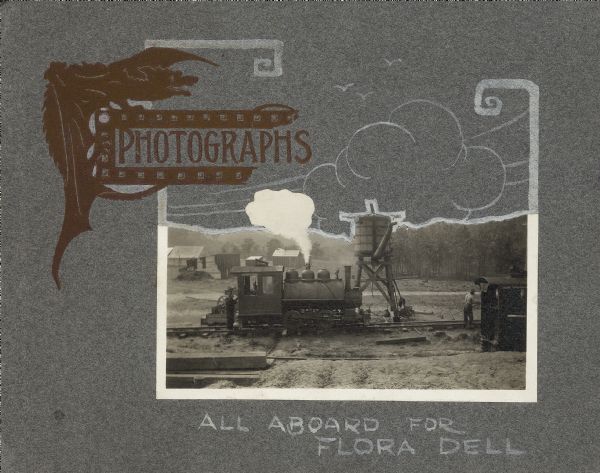 The cover of a scrapbook made for Flora Dell Lake. Features a photograph of a small locomotive on a railroad track near a water tower. There are hand-drawn sketches around the photograph, and the words: "All Aboard for Flora Dell."