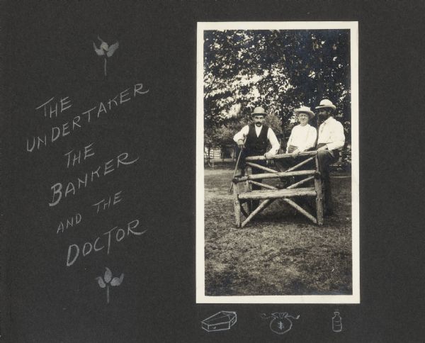 A portrait of Frank King's neighbors posed around a bench outdoors on Flora Dell Lake. From left to right, an unidentified man is described as an undertaker, the banker is identified as Frank Drew, and the doctor as Dr. Johnson Teckla. Frank Drew and his wife Lillian were in-laws of Frank King. Below the photograph, three objects represent each profession; a coffin, a money bag, and a bottle of medicine.