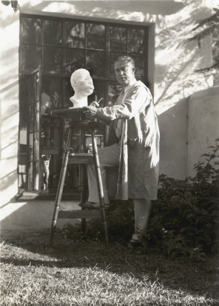 Frank O. King at home. He is working just outside the door to his sculpture studio at Folly Farm.