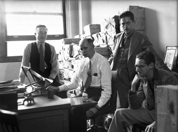 In the editorial offices of "Weird Tales" in Chicago. William R. Sprenger, secretary-treasurer of Weird Tales; Farnsworth Wright, editor; Henry Kuttner writer and agent; and Bloch the writer.
