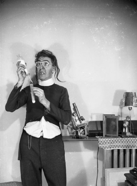 Harold Gauer as a mad scientist. Photograph stems from Gauer's work with an insurance agency and his part time testing of urine for policy purposes and life insurance signers.