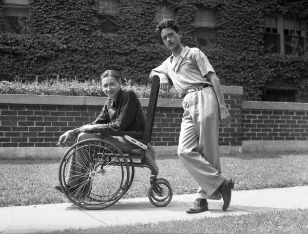 Humorous photograph taken on Maryland Avenue of Bloch in his father's wheelchair, being pushed by Henry Kuttner (agent), during a visit from Los Angeles. Bloch's father died of a "wasting" illness.