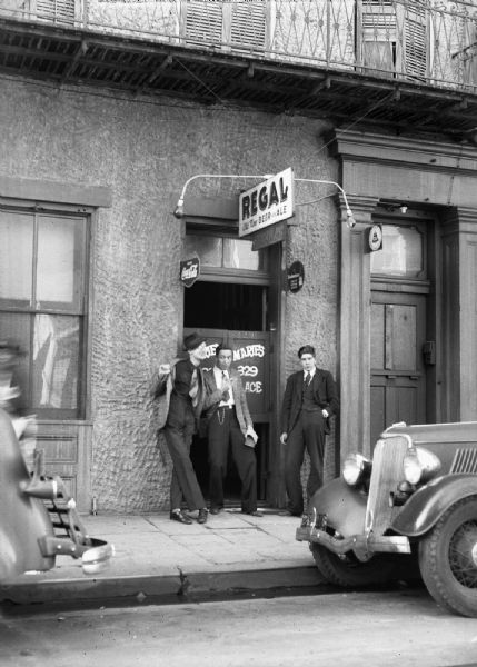 From left to right, Sprague Vonier, Robert Bloch and Harold Gauer stand at the entrance to a bar called Regal in the French Quarter in New Orleans.