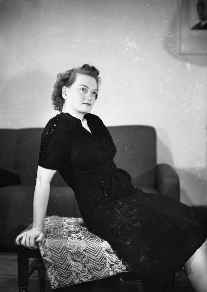 Alice Bedard posing on table in Harold Gauer's Brady Street apartment.