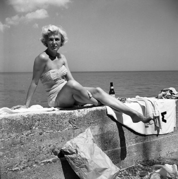 Lakeside glamour swimsuit portrait of Winnifred Woodmansee. She was chairwoman of the C.A.R.E. committee for an extended period. Her husband was owner and publisher of the <i>Daily Reporter</i>, and she was involved in all manner of local charity works alone and with her husband.