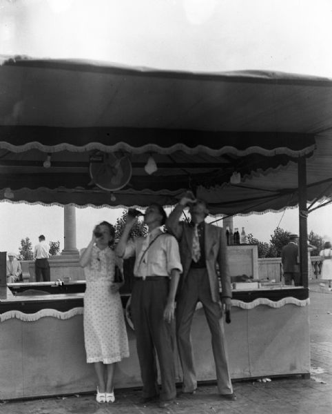Principals at the "Mid-Summer Festival." Festival was the precursor of what would become Summerfest. The gang went to the festival to "blow off steam" after they were disowned by the Zeidler people. Milt Polland promised them a concession after the festival, but it was not forthcoming. Left to Right: Alice Bedard, Harold Gauer, and Robert Bloch.