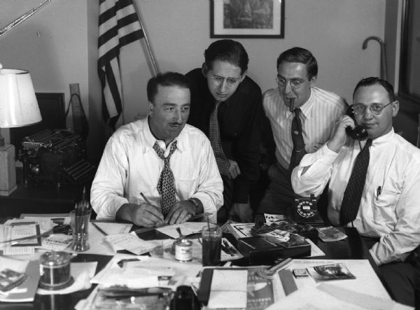 Group portrait of the total team working on the election campaign of Carl Zeidler. Max's nickname was "Max the Axe." Milt Polland always wanted to be photographed on the telephone, which spurred Harold Gauer to suggest that he get one with a chocolate mouthpiece.