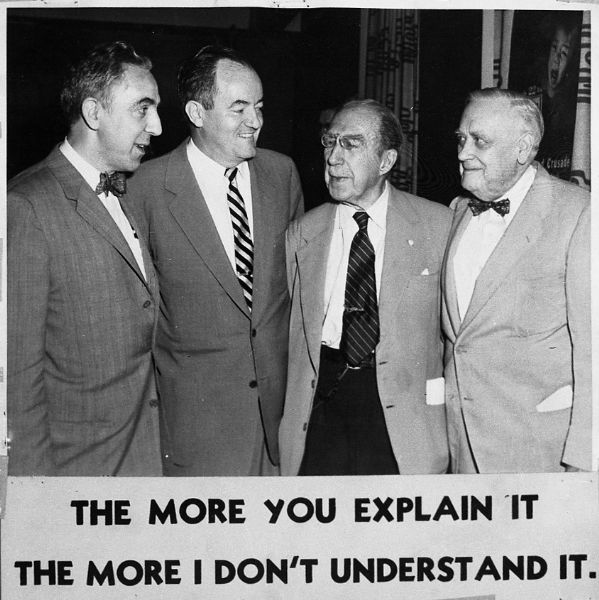 From left to right, Harold Gauer, Senator Hubert Humphrey, who at the time would have been Minnesota's Senator, Senator Theodore F. Green from Rhode Island, and Wisconsin Senator Alexander Wiley. Gauer was visiting Washington in order to persuade the "Eagles" to join CARE. The photograph has been copied with the caption "The More You Explain It The More I Don't Understand It."