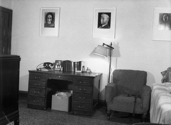 An office or study, most likely belonging to Harold Gauer, with three framed pictures hanging over a desk, of Robert Bloch, one-time Milwaukee mayoral candidate Carl Ziedler, and Harold Gauer.