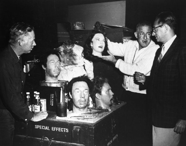 Robert Bloch on the set of <i>Strait Jacket</i>, a 1964 film starring Joan Crawford based on a book Bloch wrote. The film's director William Castle is holding up a special effects head for Bloch to see.
